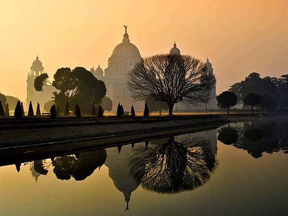 Indian temple in mist with reflecting pool of water